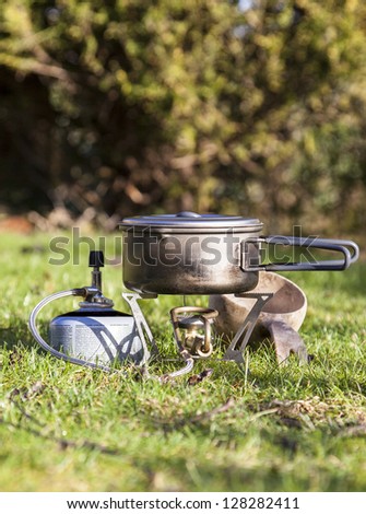 Camping stove with titanium pot and wooden cup
