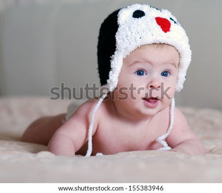 happy baby in a hat with a penguin