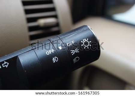 Lights on/off switch in a car, shallow focus depth