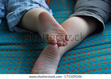 Close-up feet, older brother and younger brother.