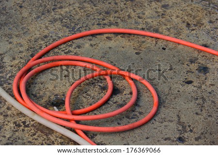 Hose tangled on cement floor