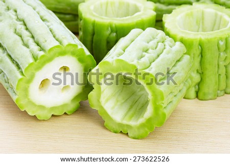 Bitter gourd slices on wooden in white background