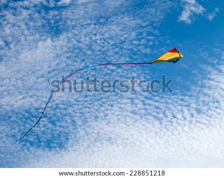 flying kite against blue sky