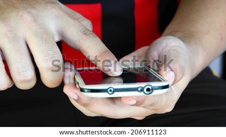 closeup of two man hands using smart phone
