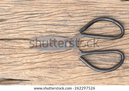 top view of black scissors on wood table