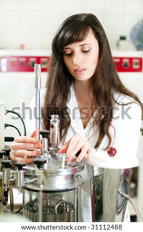 Young pretty laboratory assistant takes experiments at a renewable energy laboratory