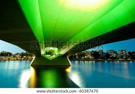 Wide angle perspective of the green bridge reflecting in the river