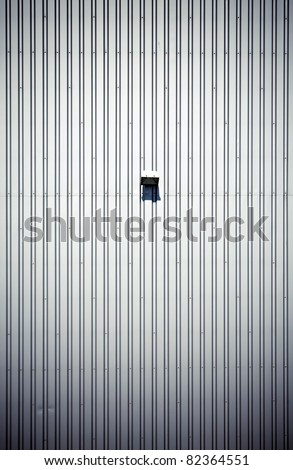 Simple empty steel factory wall with lamp