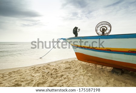 Traditional fishing boat on the beach of the Mediterranean sea before the storm