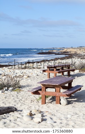 Bench and table on the sand of the Pacific ocean coast at 17 mile drive