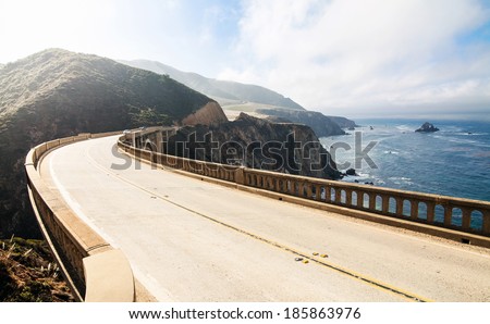 Highway between mountains and pacific ocean. Bixby Bridge at Big Sur