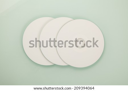 Blank CD or DVD on gray background.