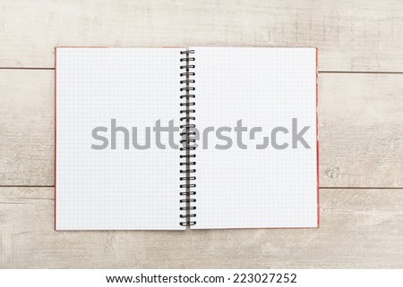 White open notebook on white wood background.