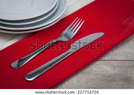 Empty Plate, Fork, Knife on wooden background. Top View with Text Space