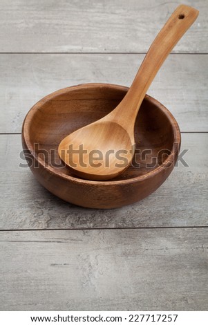 Empty bowl, vintage cutting board on planks food background concept