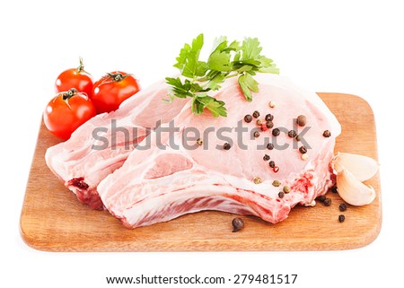 raw meat : fresh beef pork fillet pieces with garlic and green stuff on wood isolated over white background