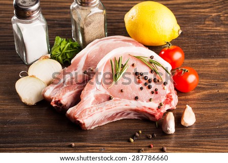 fresh raw pork loin with bay leaf on wooden board