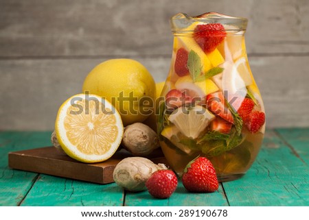 Strawberry lemonade with lemon on wooden table. Selective focus.