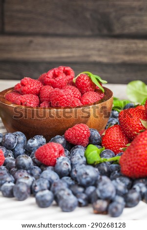 Berries on Wooden Background. Summer or Spring Organic Berry over Wood. Selective focus