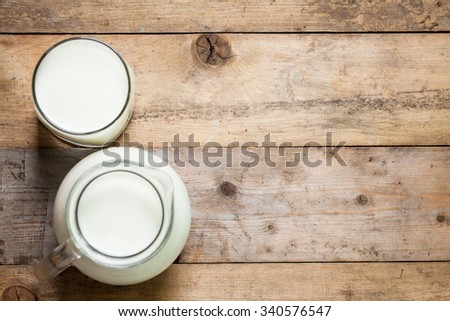 Fresh Milk on Glasses Bottle, Dairy Produce Concept of Breakfast on Wood Table Background, Country Rustic Still Life Style, Vintage Tone, Top view. Space for text.
