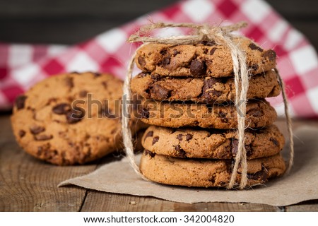freshly baked chocolate chip cookies on rustic wooden table