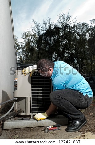 Hispanic air conditioning system repair maintenance man