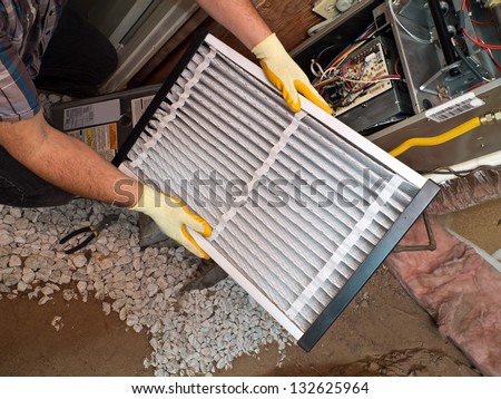 Hispanic Airconditioning Repair Man Performing Maintenance