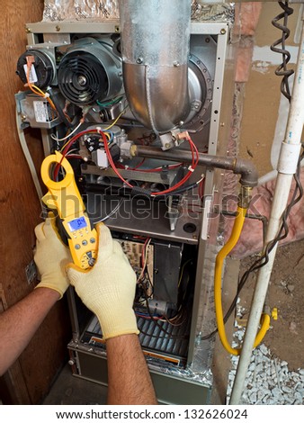 Hispanic airconditioning repair man performing maintenance