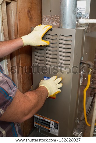 Hispanic airconditioning repair man performing maintenance