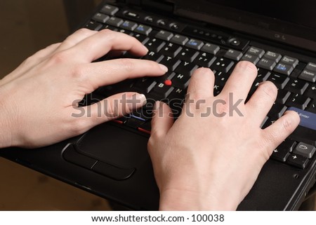 Woman's hand typing on laptop