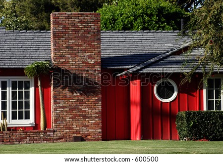 Red suburban house with round window