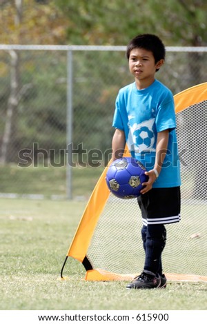 Young boy playing goalie in soccer
