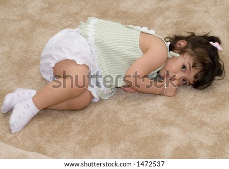 stock photo cute little girl laying down sucking her thumb