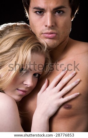 Attractive young blond woman leaning on the bare chest of attractive young brunette man
