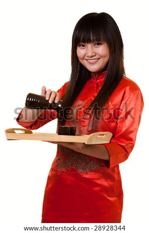 Attractive asian woman wearing orange satin chinese attire holding a tray with a saki cups and jug