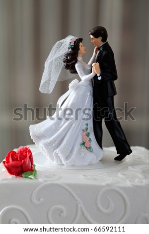 stock photo Wedding cake and topper with couple dancing