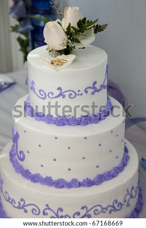 stock photo Wedding cake and topper with rings