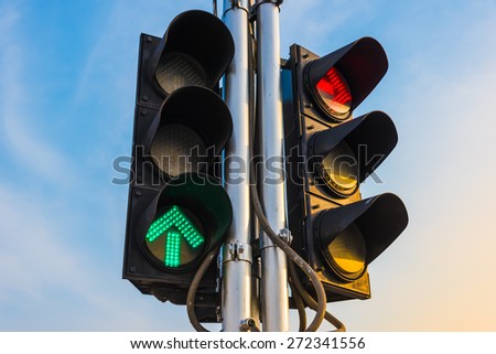 Red and Green color on the traffic light with a beautiful blue sky before the sun set