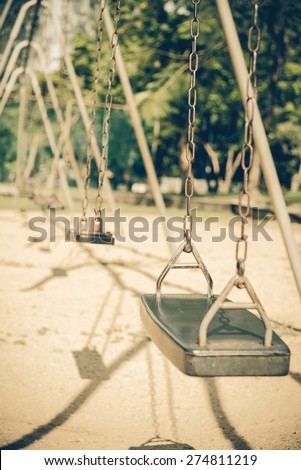 Empty old swing in motion - Vintage picture style