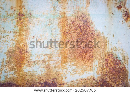 rusty metallic background with shabby old paint and aged by time