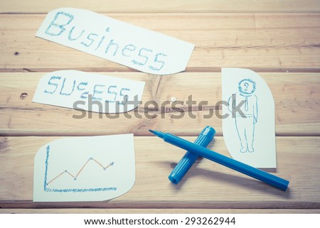 Hand writing a business concept on the wooden board - vintage retro picture style