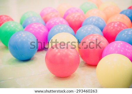 holiday, children's party, a games room, a box filled with small colored balls - vintage retro filter