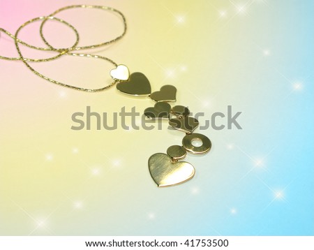 The chain with hearts is located against with patches of light