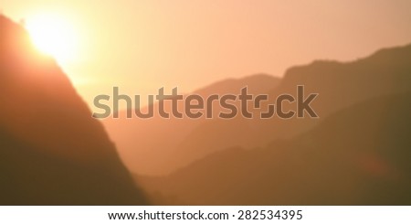 Beautiful Sun light on the mountains . Abstract blur background .