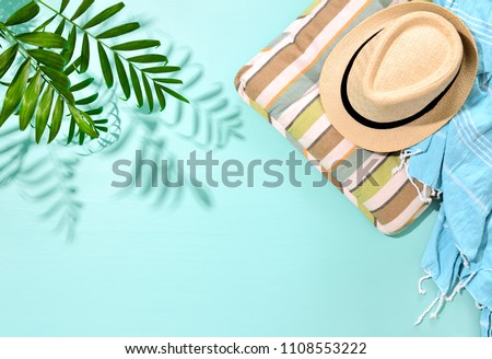 Sunny summer concept background with a strong shadow of palm leaf and blank space for a text, view from above, flat lay composition