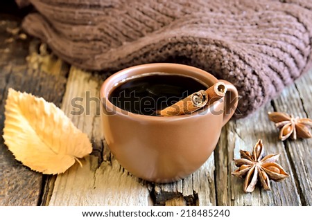 Coffee cup with cinnamon in an autumn morning