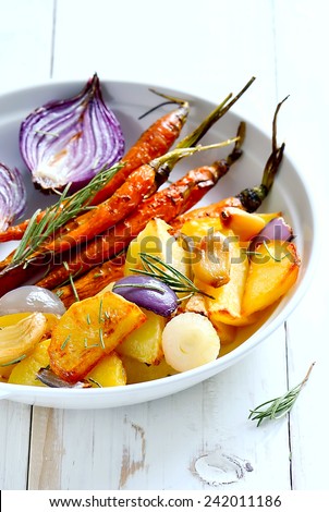 Roasted vegetables in a white plate. Vegetarian dish.