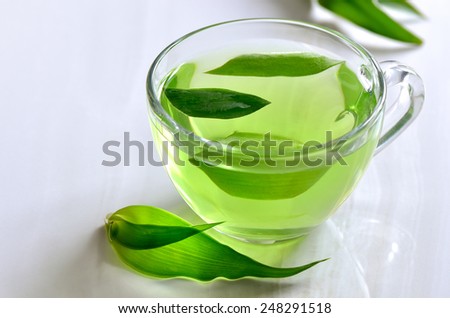 Green spa tea in a glass cup, detox and relaxing warm drink