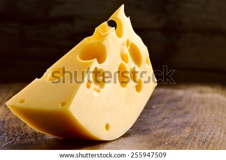 Block of cheese on a wooden background