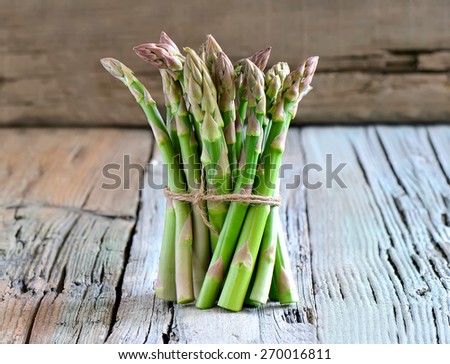 Bunch of first green spring sprouts of asparagus harvested in garden